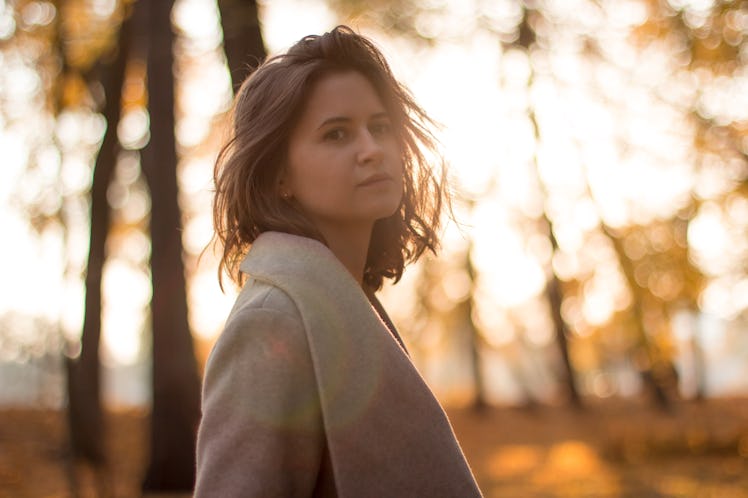 Girl in the autumn forest on the backlight