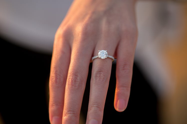 A newly engaged person shows off her ring. 