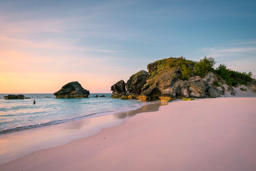 Sunrise at Horse Shoe Bay in South Hampton, Bermuda with an early riser swimmer
