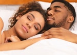 True love. Black couple sleeping together, cuddling in bed, closeup