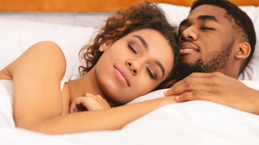 True love. Black couple sleeping together, cuddling in bed, closeup