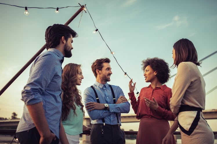 Cropped shot of a group of friends having a conversation on a boat