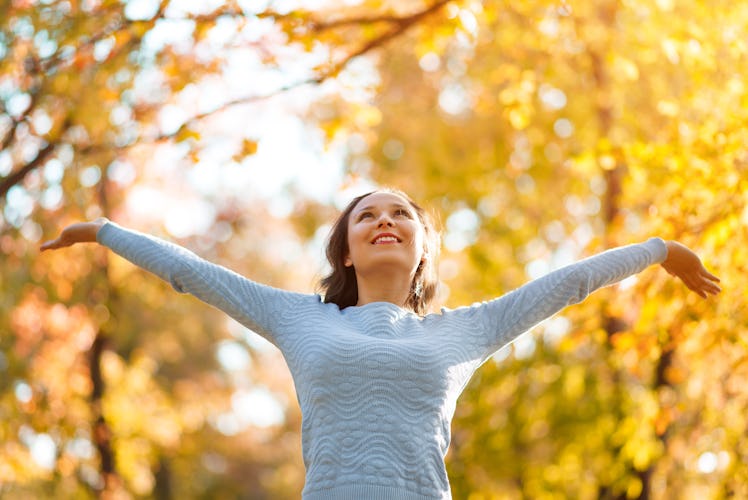 happy girl enjoying life and freedom in the autumn on the nature. autumn concept