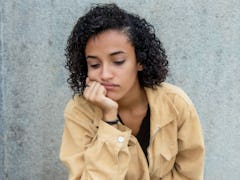 Sad and lonely latin american woman outdoors with copy space