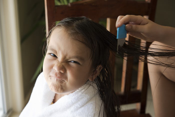 a girl is upset face, she got head lice from a school friend and do combing treatment