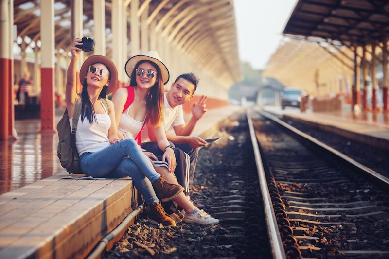 friendship, travel, vacation,Group of happy enjoy friends traveling at train station.Together concep...