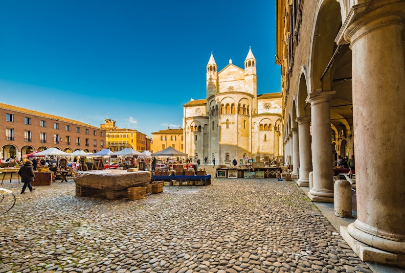 stalls of antique market in the main square of Modena in Italy
