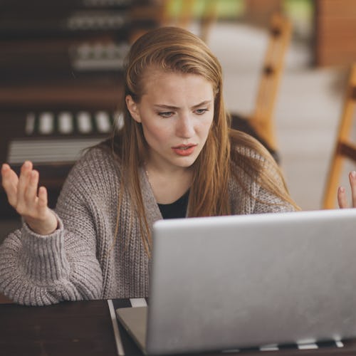 Frustrated worried young woman looks at laptop upset by bad news, teenager feels shocked afraid read...
