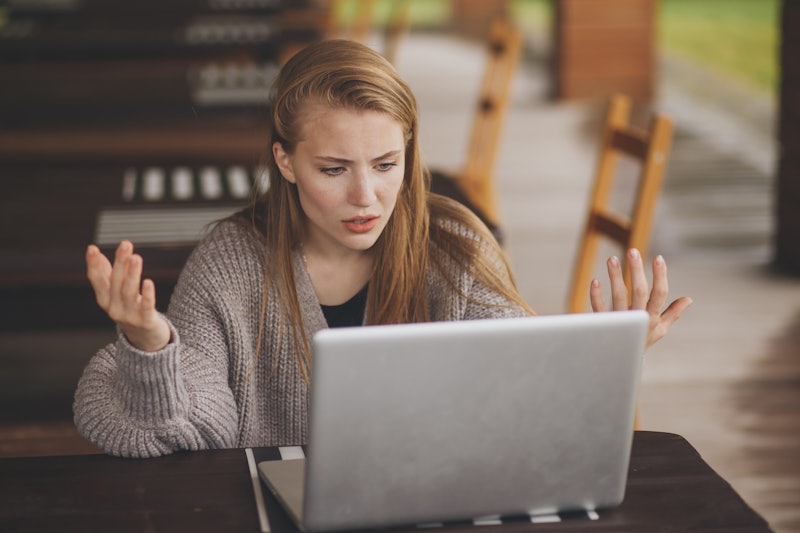 Frustrated worried young woman looks at laptop upset by bad news, teenager feels shocked afraid read...