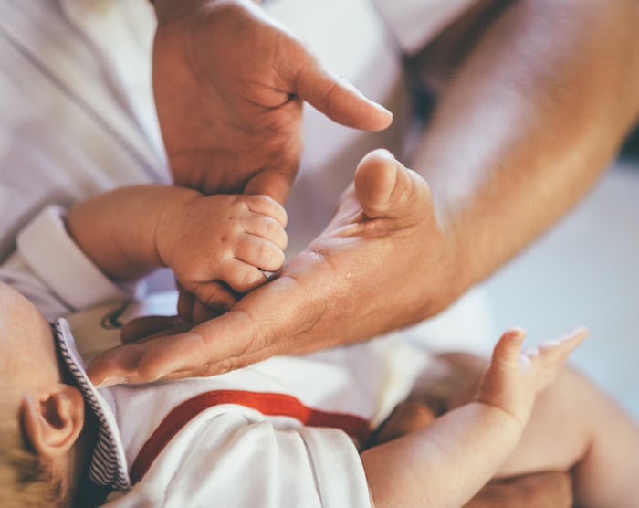 dad and newborn cute small hands first days
