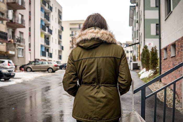 Lonely woman walking on the street, on a rainy day