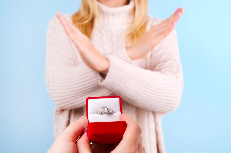 She said NO concept. Young girl rejects the marriage proposal. Woman refuses the engagement gold pla...