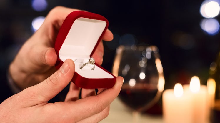 Man's hands holding box with ring making proposal. Proposal on Valentine day concept