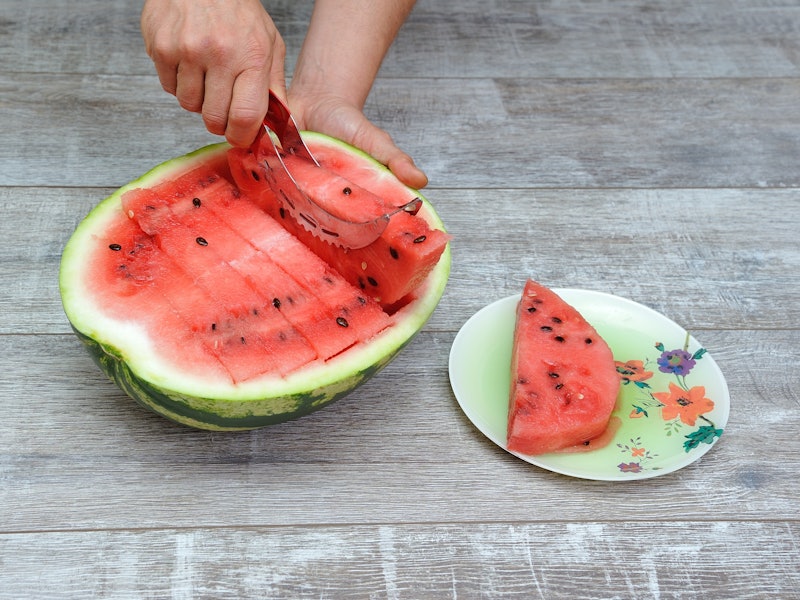 Preparing vegan food made of watermelon sliced with a slicer