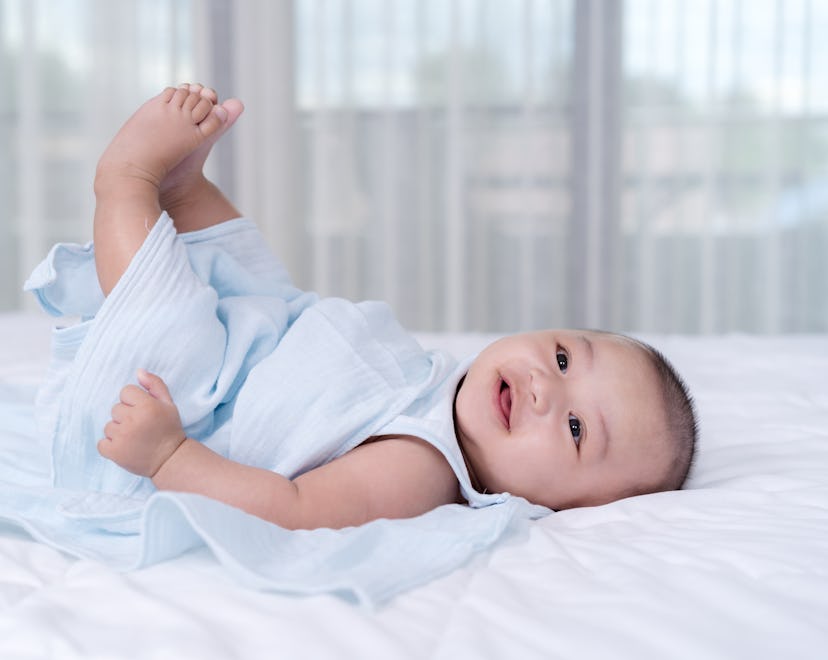 little baby move leg in the air on a bed
