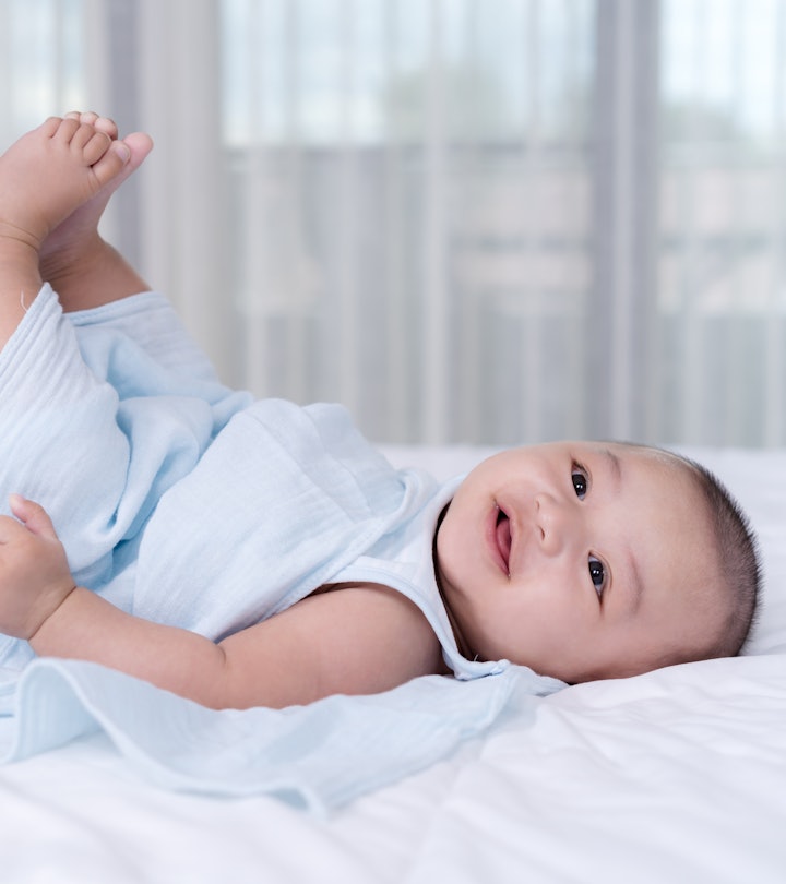 little baby move leg in the air on a bed