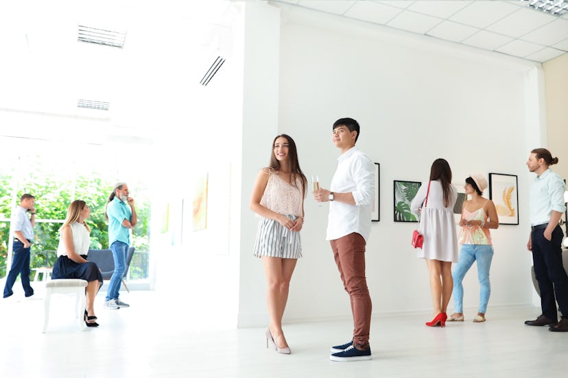 Young couple at exhibition in art gallery