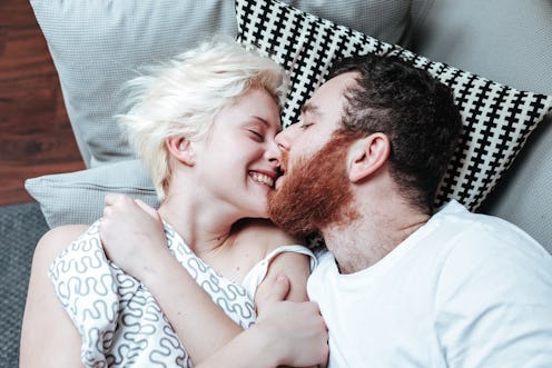 Closeup portrait of happy young couple in bed.