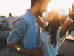 Couple flirting while having a drink on rooftop terrasse