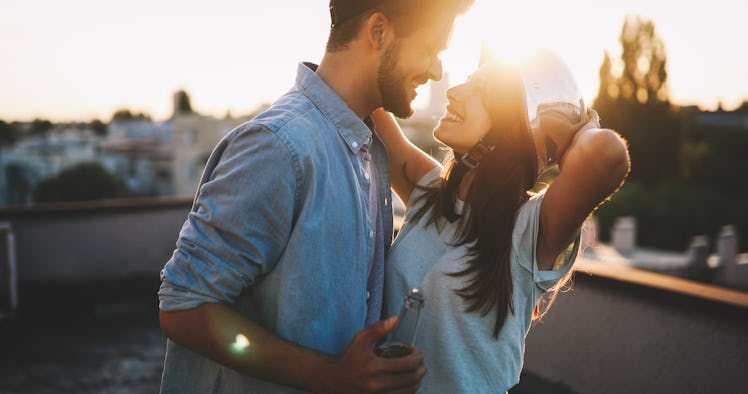 Couple flirting while having a drink on rooftop terrasse