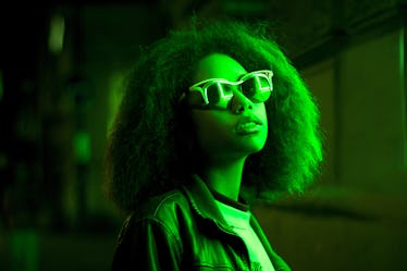 High Fashion. Young Beautiful woman with Trendy glowing neon hairstyle, stylish makeup. Sexy adorabl...
