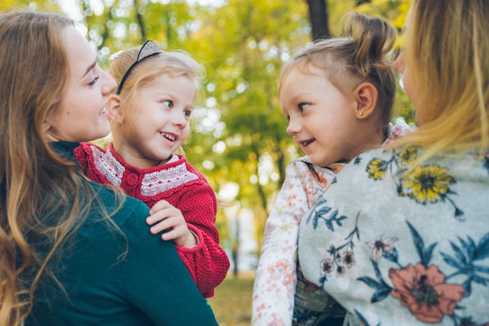 mother daughter love hug at autumn city park fall season