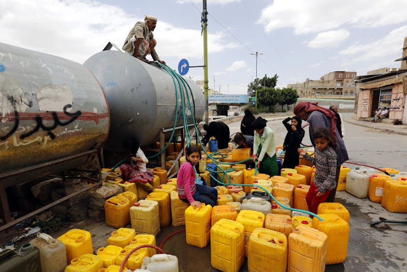 People collect clean water from a donated source in Sana'a, Yemen, 22 August 2019. According to repo...