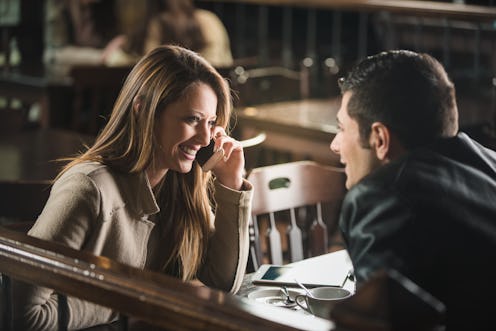Young cheerful man and woman dating and spending time together at the bar