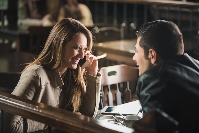 Young cheerful man and woman dating and spending time together at the bar