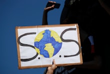 A protester shows a placard during a climate demonstration in Paris. In Canberra and Kabul, Cape Tow...
