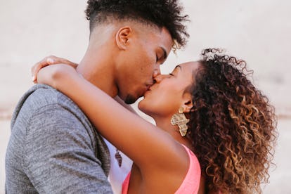 close up of heterosexual ethnic couple kissing outdoors