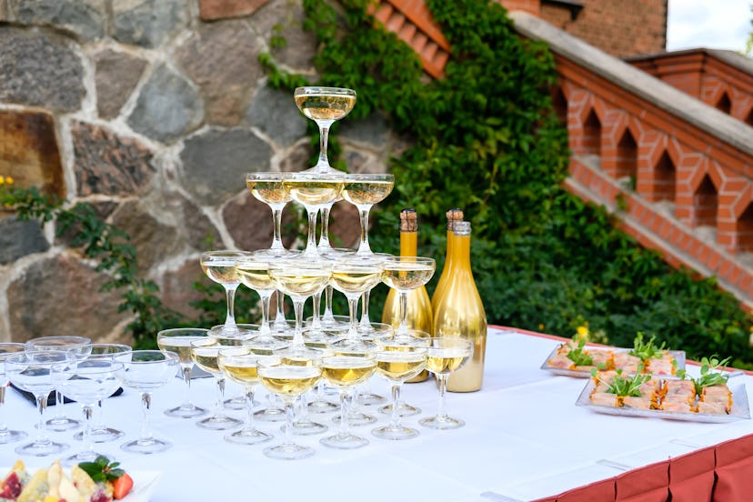 Champagne glass pyramid. Pyramid of glasses of wine, champagne, tower of champagne on wedding party....