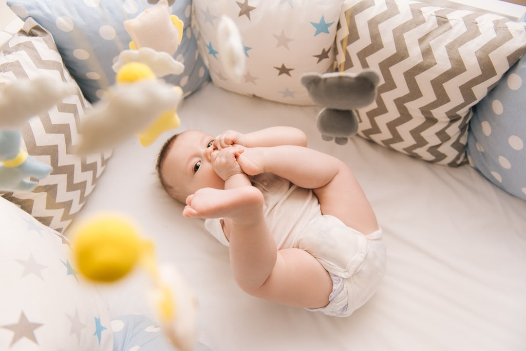 Why Do Babies Put Their Toes In Their Mouths? Experts Explain