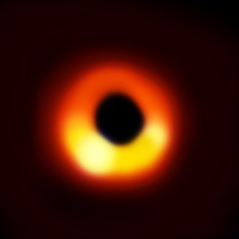 A black hole surrounded by orange and yellow lights
