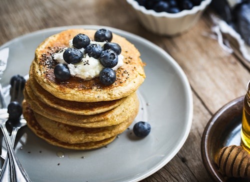 Banana Oat Pancakes with Blueberries, Coconut cream and Chia top