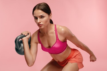 Workout. Woman Training With Dumbbell On Pink Background
