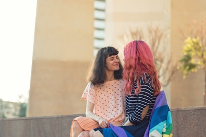 bisexual girls relationship lesbian young girls smiling on the street with romantic gesture. lesbian...