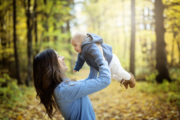 A Mother with daughter baby in autumn forest