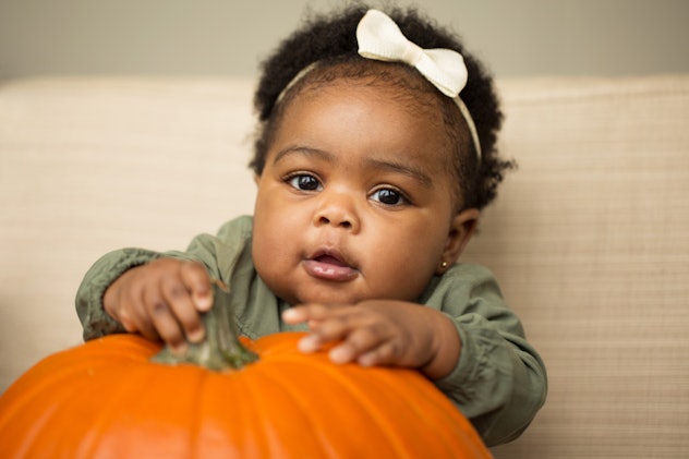 Cute little girl with a pumpkin.