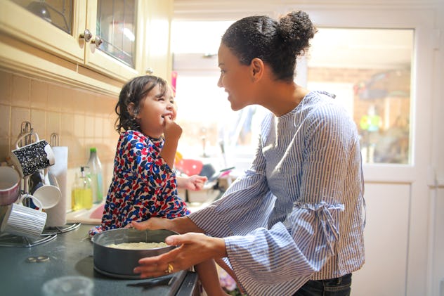 Sweet mother and daughter cooking together