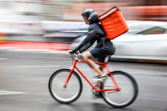 delivery on the bike in traffic on the city roadway  motion blur