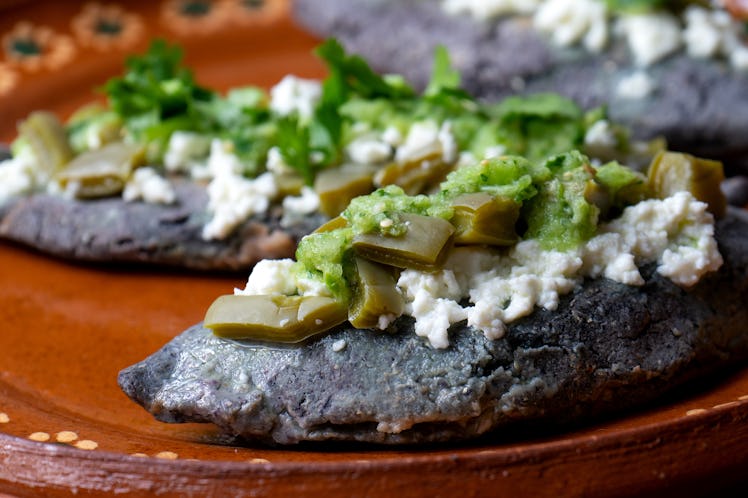 Traditional mexican tlacoyos with green sauce and nopal cactus