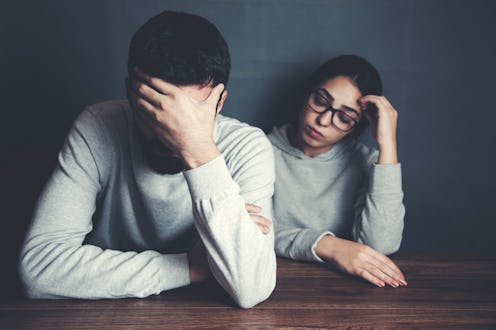 young sad couple sitting in table