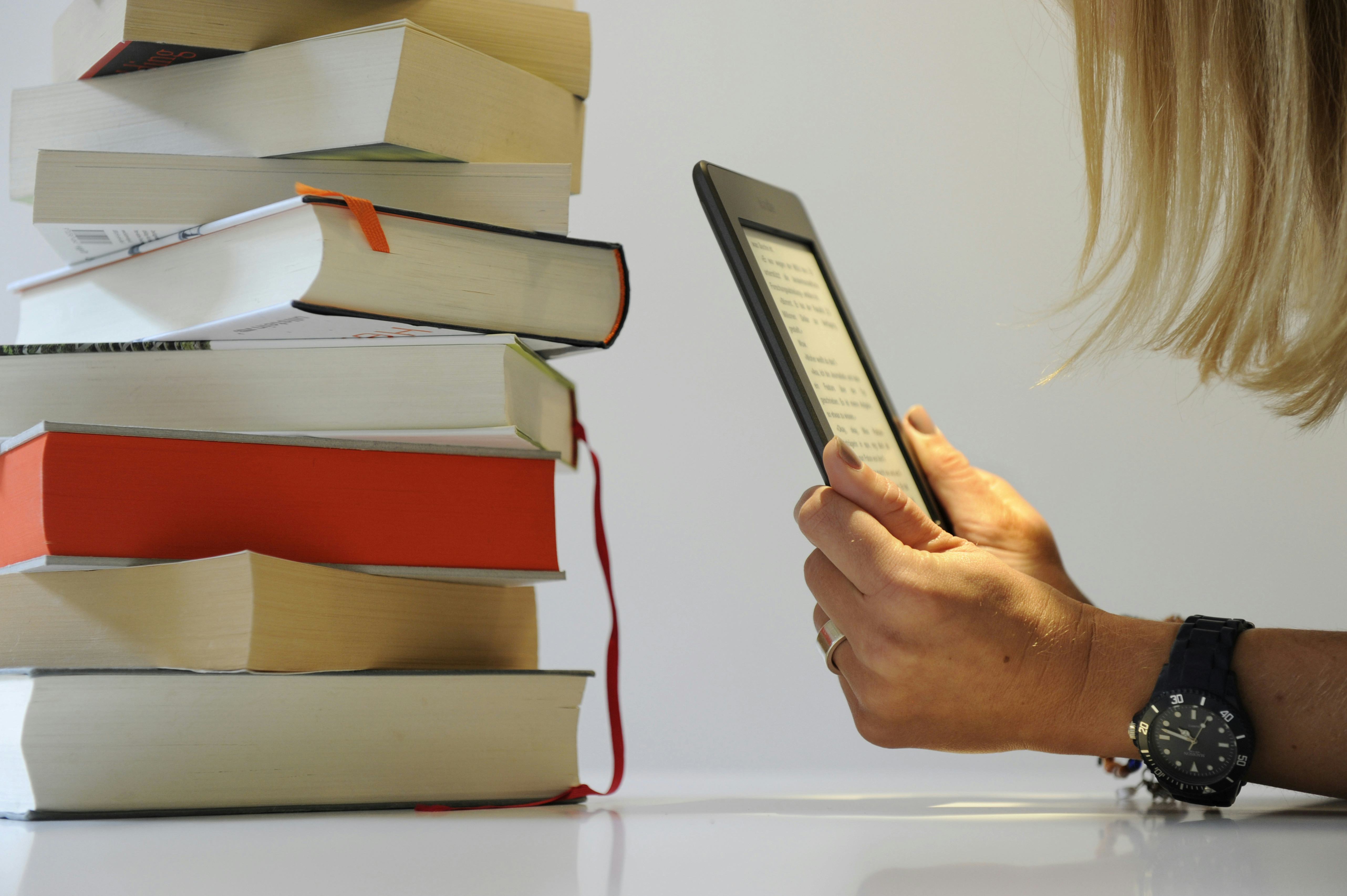 Young woman reading an e-book on a Kindle
