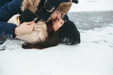 man and woman kiss on the ice, close view