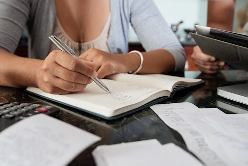 Housewife calculating expenses and taxes that need to be paid