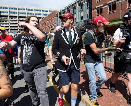 Milo Yiannopoulos (C) is flanked by security as he takes part in the 'Straight Pride Parade' in Bost...