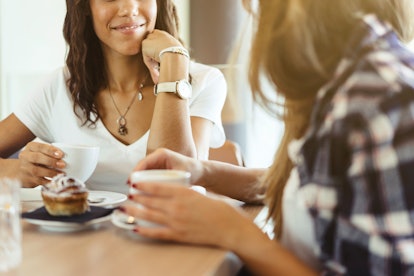 two young girls talking in a cafeteria