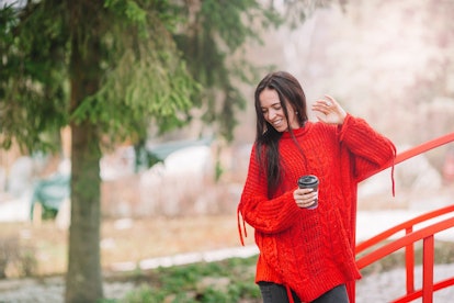 Woman with coffee in the forest on weekend and enjoy the nature