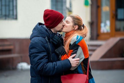 couple kissing outside in spring.